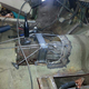 Fitting the Nissan five-speed transmission into the car.
